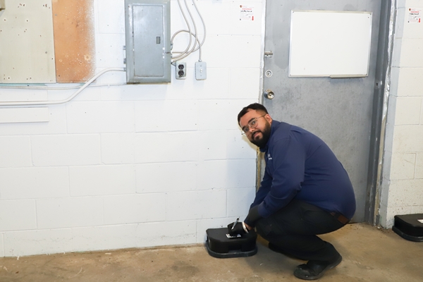 Husky Pest Control technician performing commercial pest inspection at warehouse
