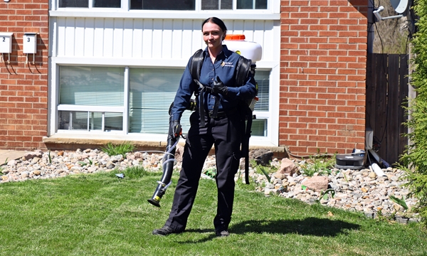 Husky Pest Control technician performing mosquito barrier treatment